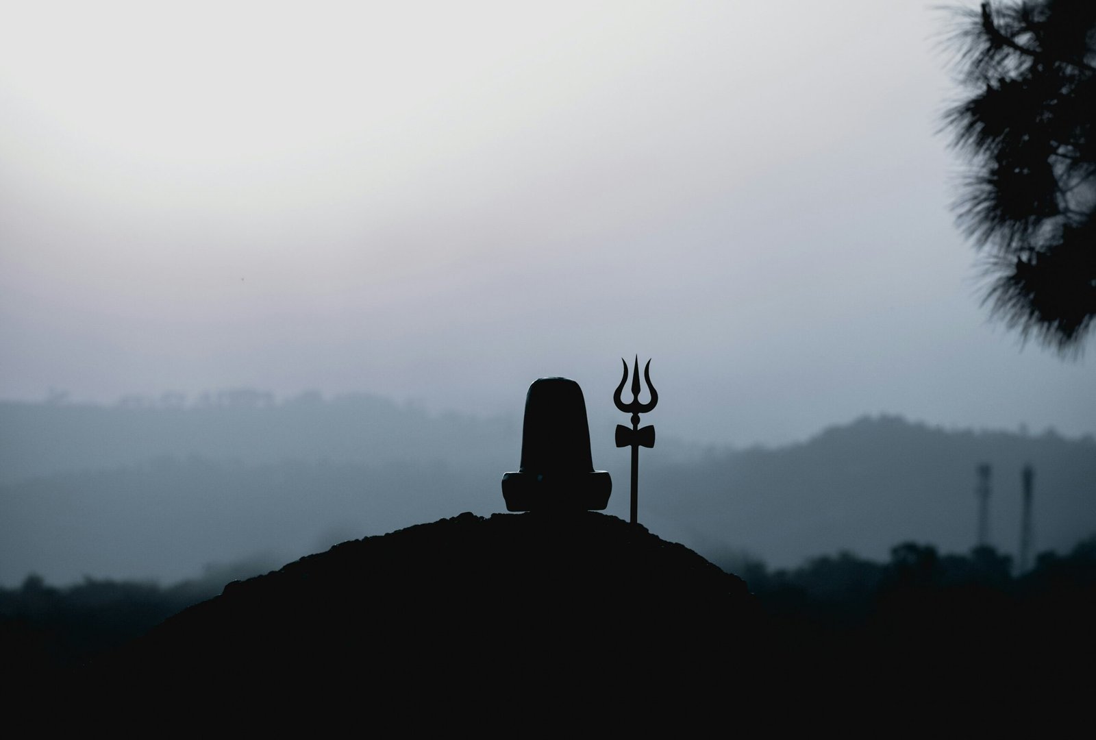 silhouette of man standing on top of mountain during daytime